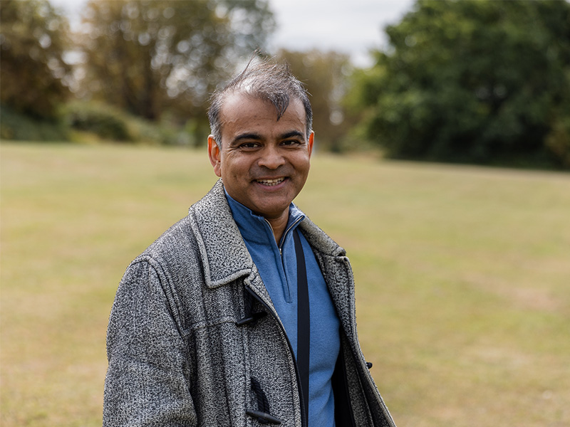 Amir Hoosein standing outside.