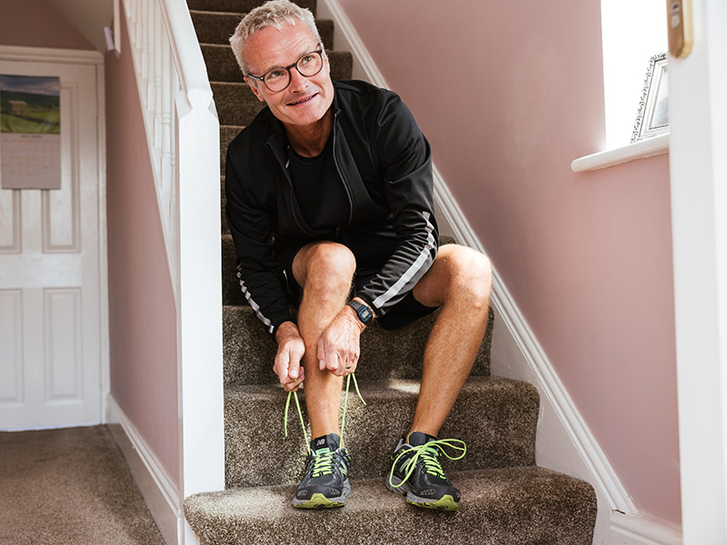 Nigel putting on his running trainers.