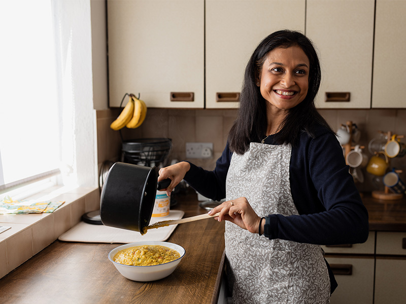 Puloma cooking at home in her kitchen.