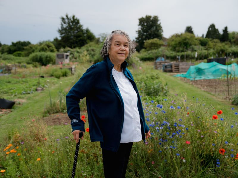 Marion Blake from Luton stands in front of some meadow flowers at the allotment where she grows vegetables.