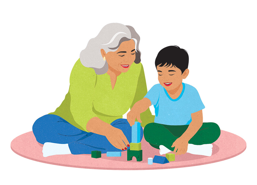 An older person sitting on the floor playing with a young child