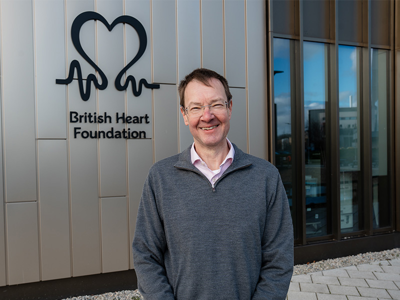 Professor Wilkinson standing outside a building with British Heart Foundation's logo.