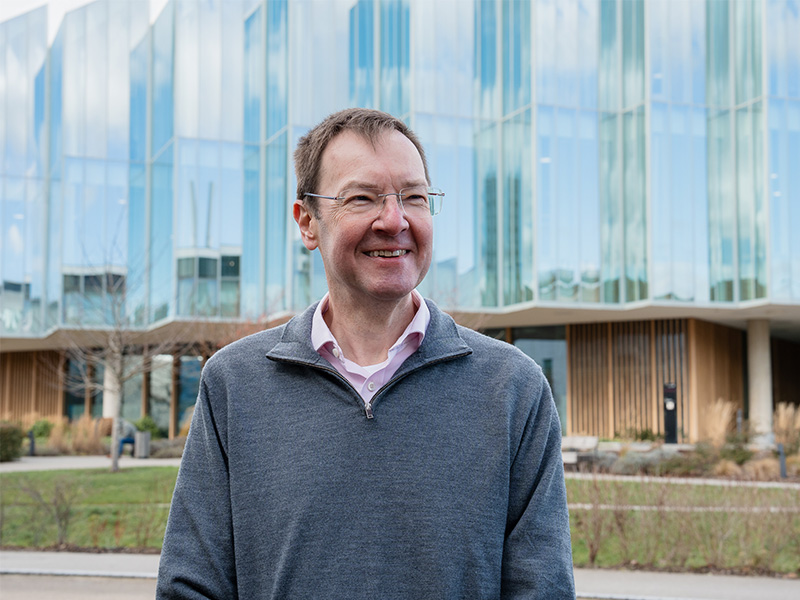 Professor Ian Wilkinson outside in front of a building.