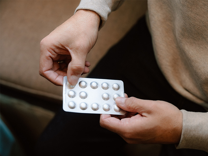 Ben holding a packet of statin medicine.