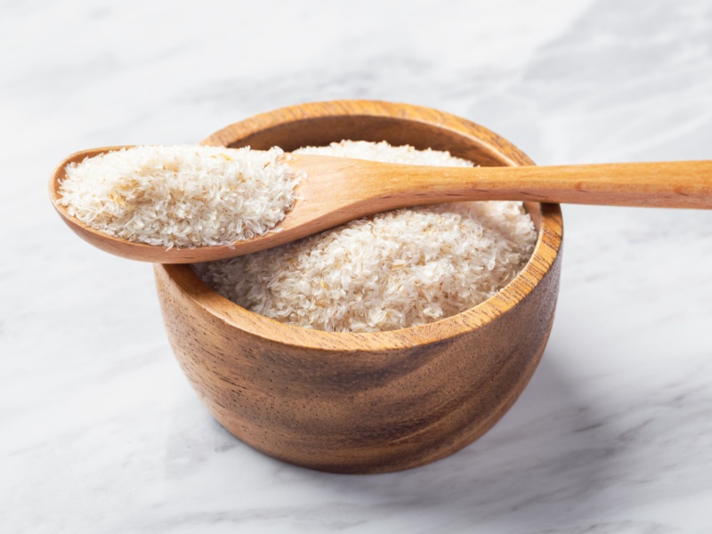 A wooden bowl of psyllium husk powder.