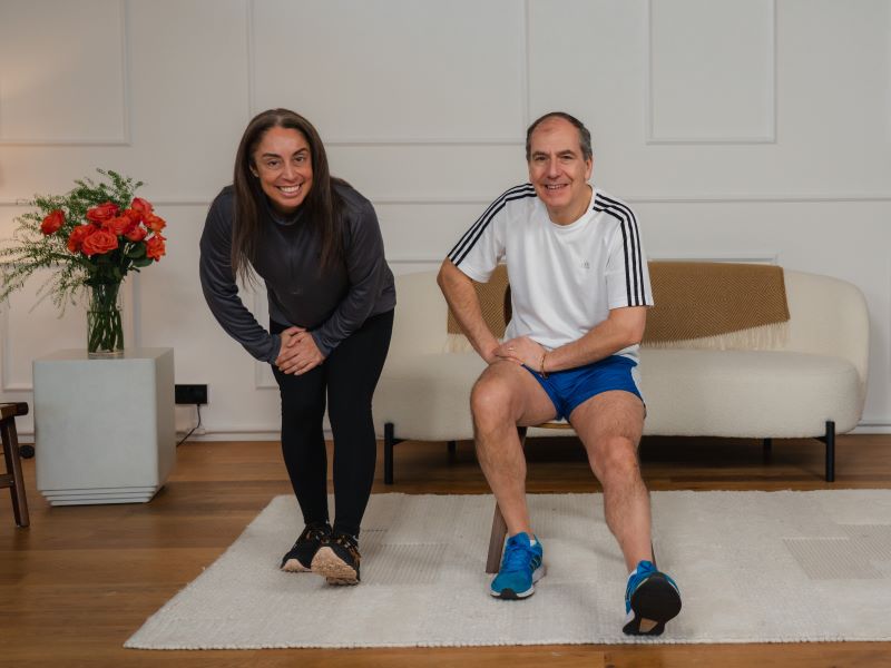 Hara and Stefano performing a hamstring stretch.