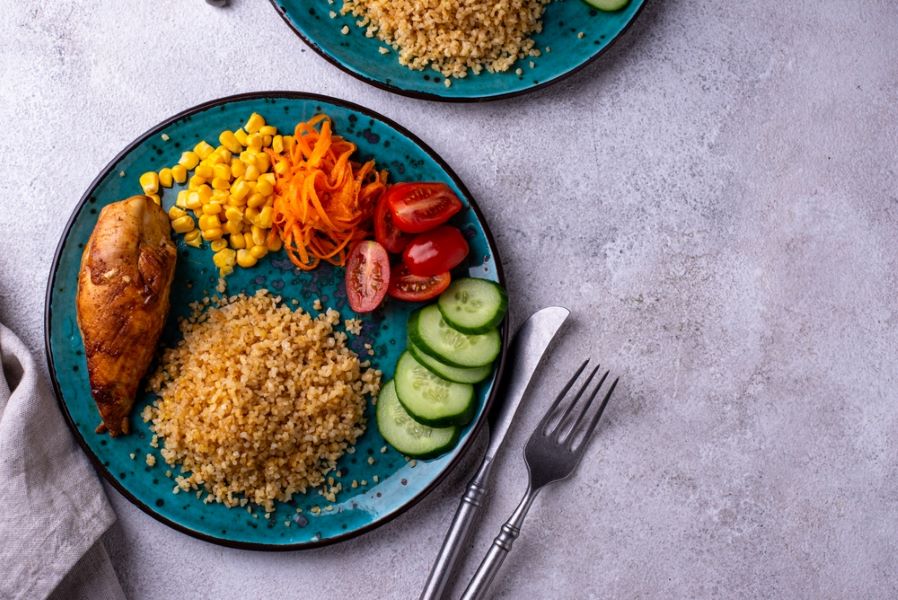 Healthy, balanced food plate with chicken and vegetables