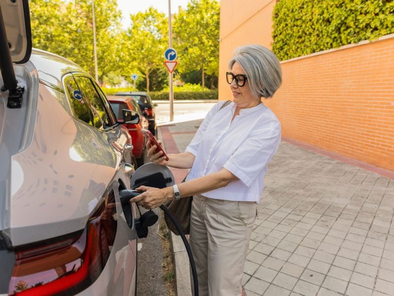 Woman charging an electric car