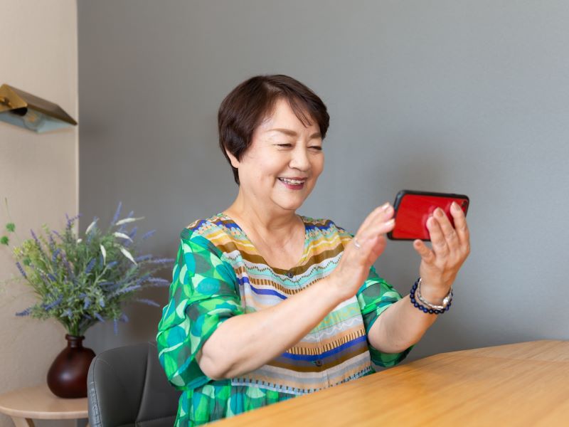 Woman holding a mobile phone in front of her for a video call