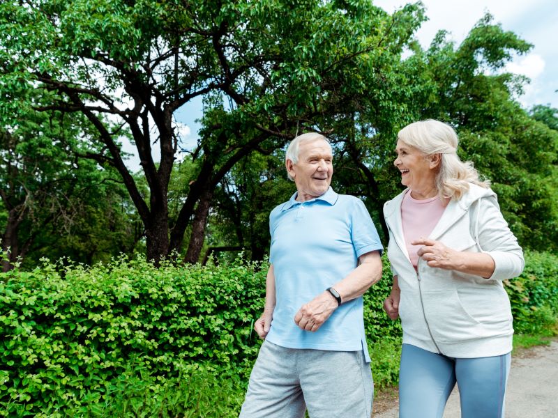 Man and a woman talking as they walk for exercise