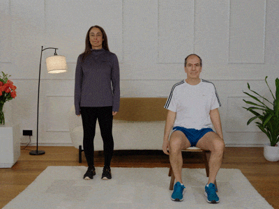 Hara and Stefano performing foot pedals with alternating bicep curls.