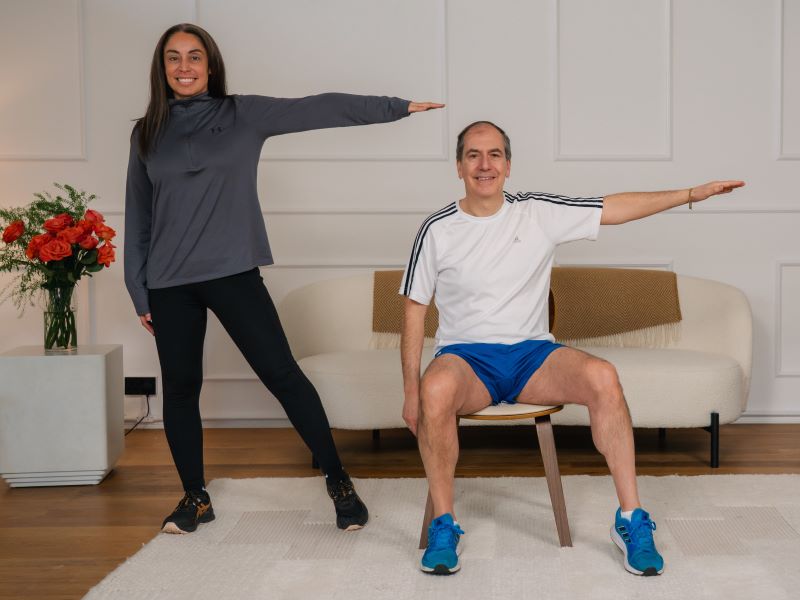 Hara and Stefano warming up by performing a side tap with side raise.