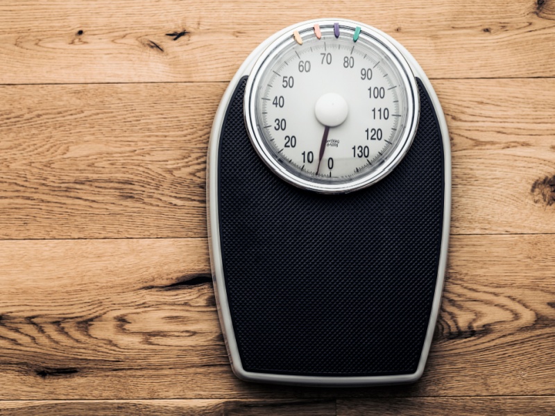 A set of weighing scales on a floor.