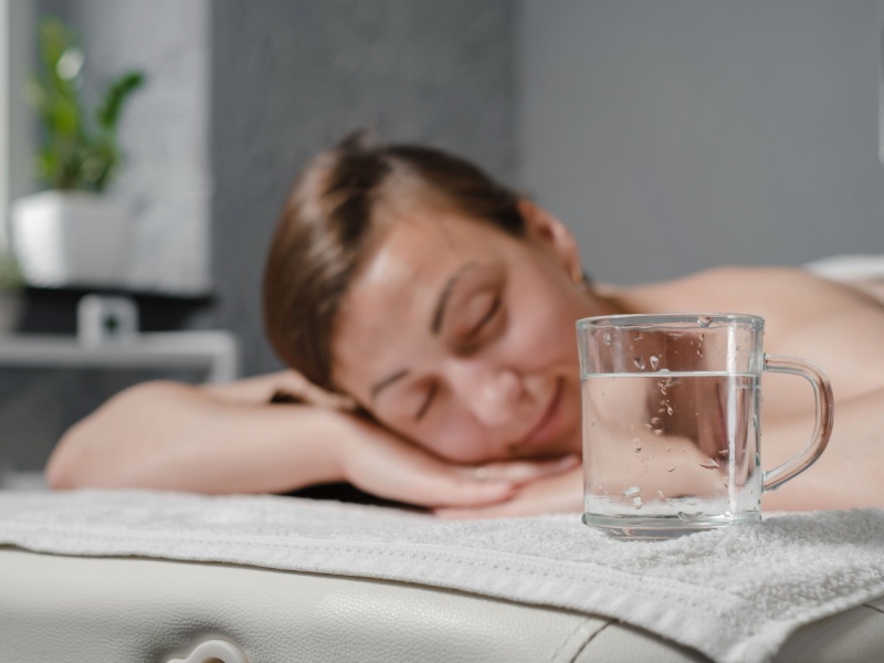A woman lying on her front on a massage table.
