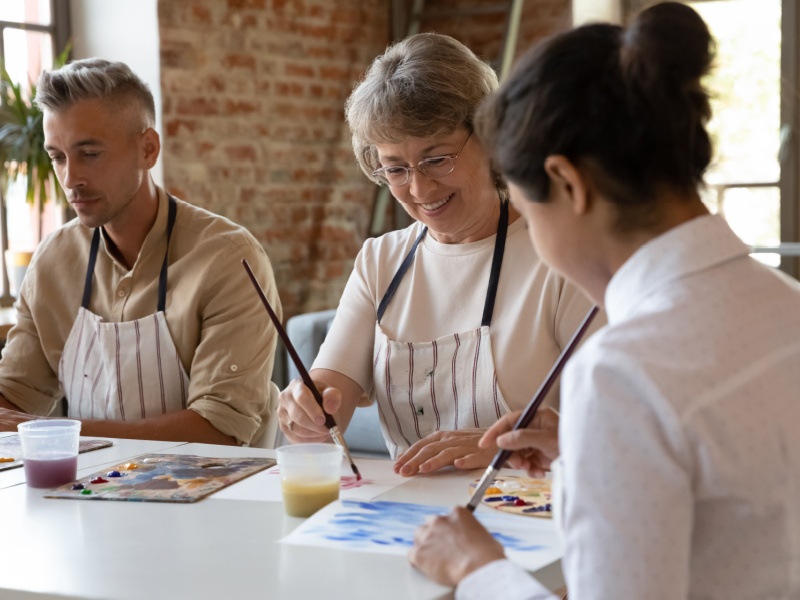 People painting in an art class.