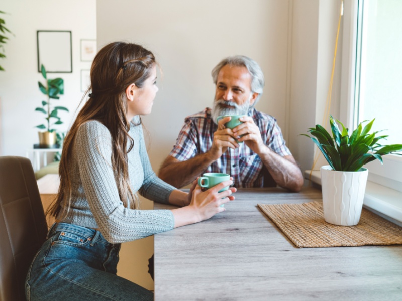 A man and woman having a cup of tea or coffee together.