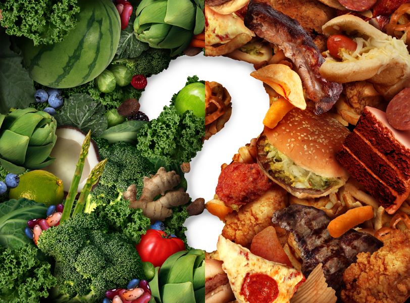 A question mark surrounded by healthy foods and unhealthy foods  