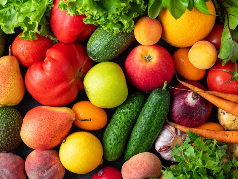 Fresh fruits and vegetables on a table from above.