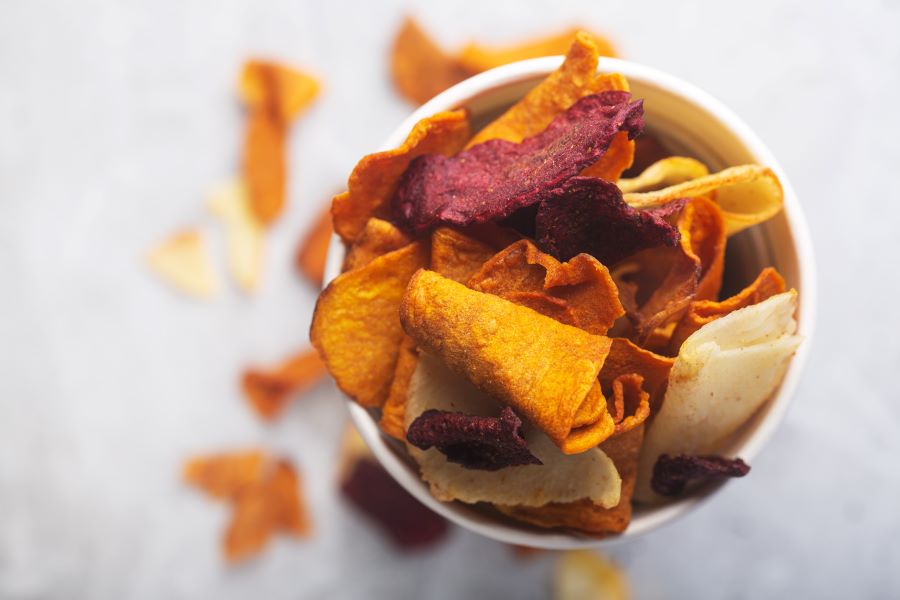 A selection of vegetable crisps in a bowl.