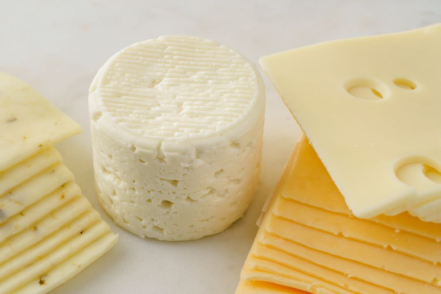 Selection of cheese, including Cheddar slices.
