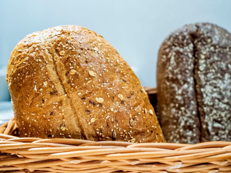 Wicker basket of fresh, wholemeal breads.