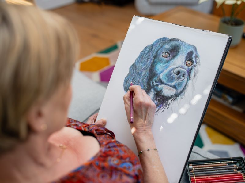 Linda drawing a picture of her dog, Ethel.