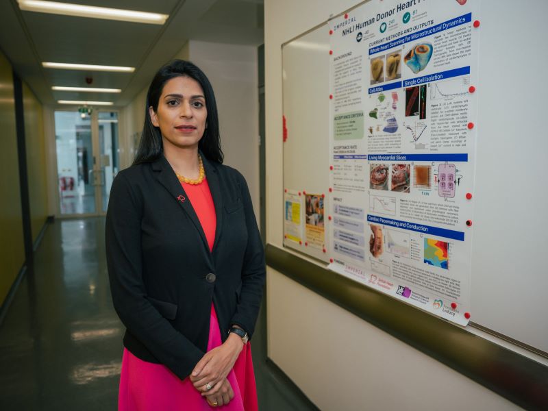 Dr Alicia D'Souza with a poster explaining how human heart tissue is being used for research.