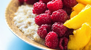Porridge topped with peaches and raspberries