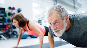 Senior couple working out at a gym