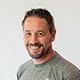 A headshot of Andrew Scard.