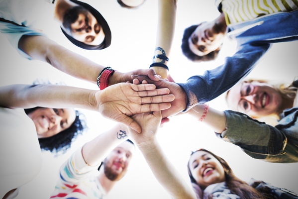 Group of diverse people touch hands 