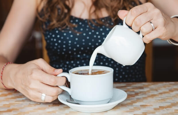 Pouring milk into coffee