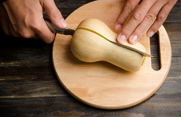 butternut squash being cut in half