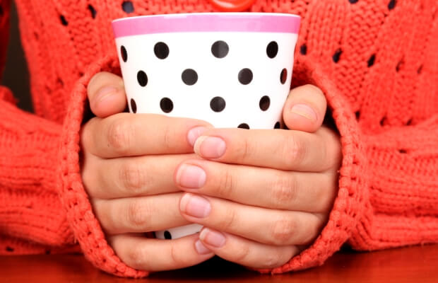 Woman's hands around a warm drink