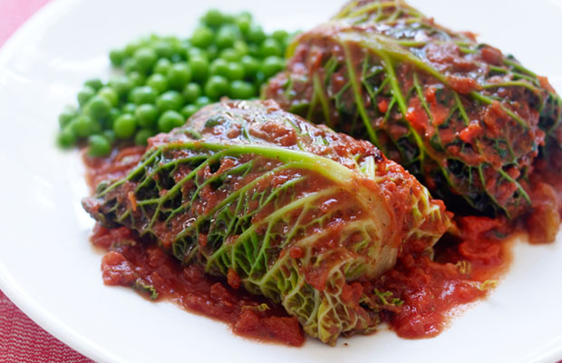 Stuffed cabagges served with cooked green beans or peas
