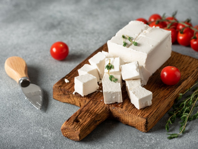Feta cheese on a chopping board.