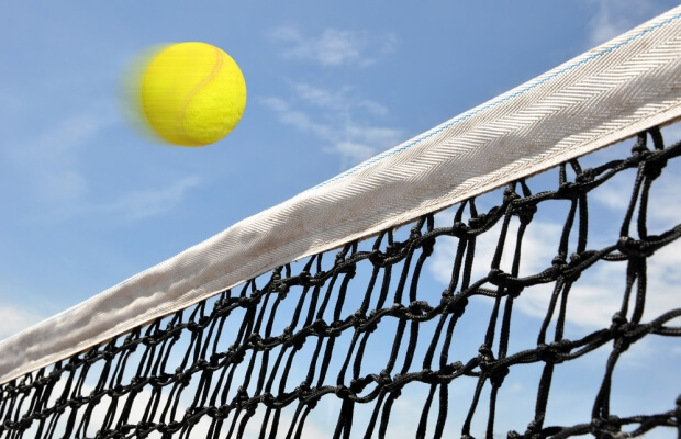 Ball going over a tennis net