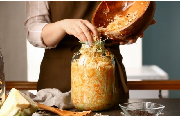 A person making pickled cabbage.