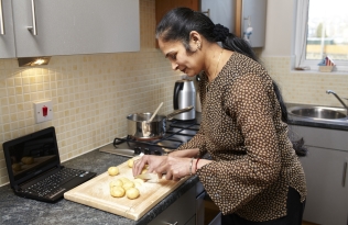 A woman chopping potatoes 