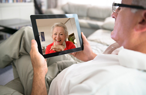 A man contacting her wife on his iPad using Skype