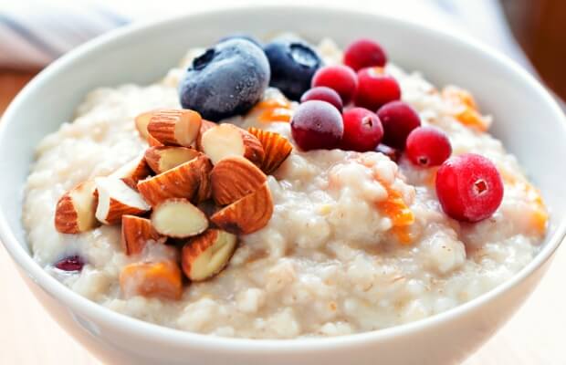 A breakfast of porridge with frozen berries and nuts