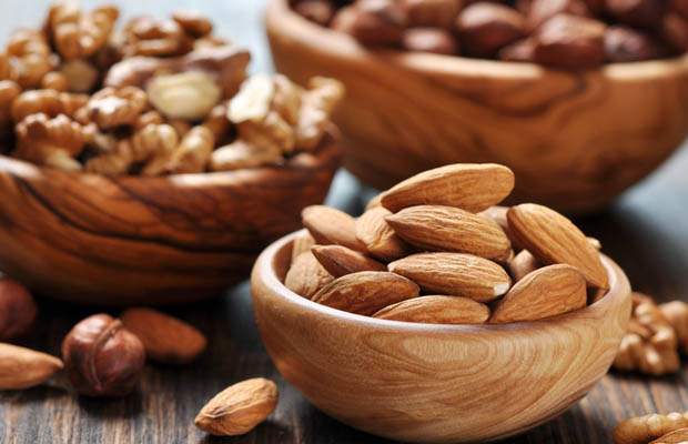 Almonds, walnuts and hazelnuts in bowls on a table