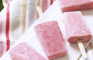 Summer fruit smoothie ice lollies on a summer picnic blanket