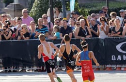 Runners getting support from a cheering crowd at a race