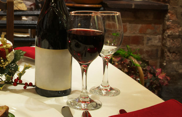 A glass of red wine on a festive table