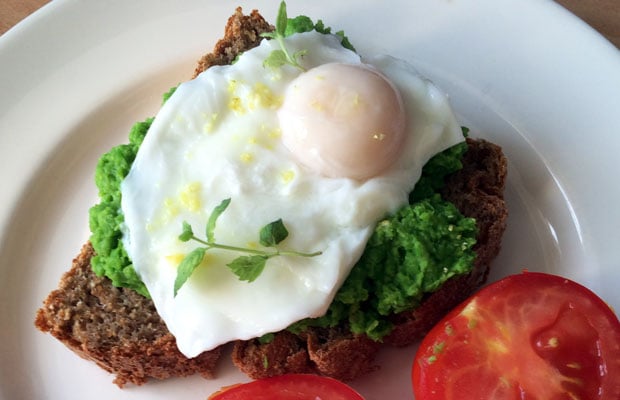 Smahed peas on toast with poached eggs