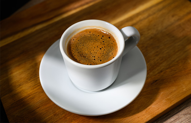 A cup of coffee on a table.