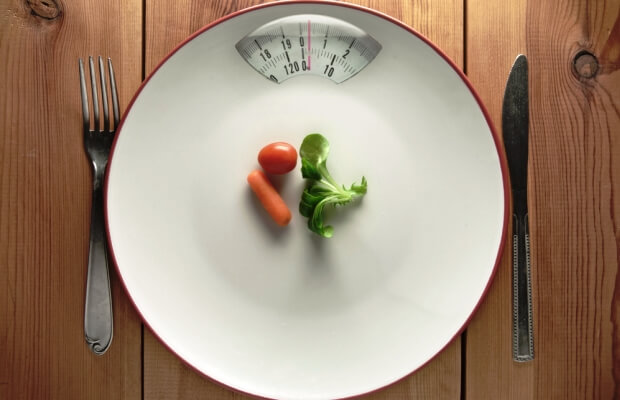 Dieting concept with scales and plate