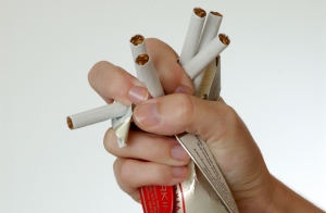 Crushing a packet of cigarettes 