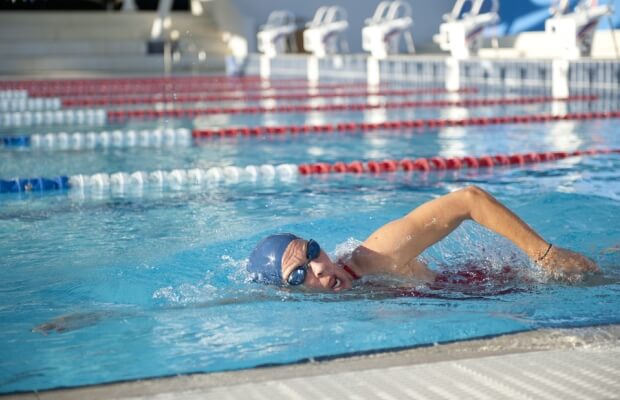 Lady swimming freestyle in pool